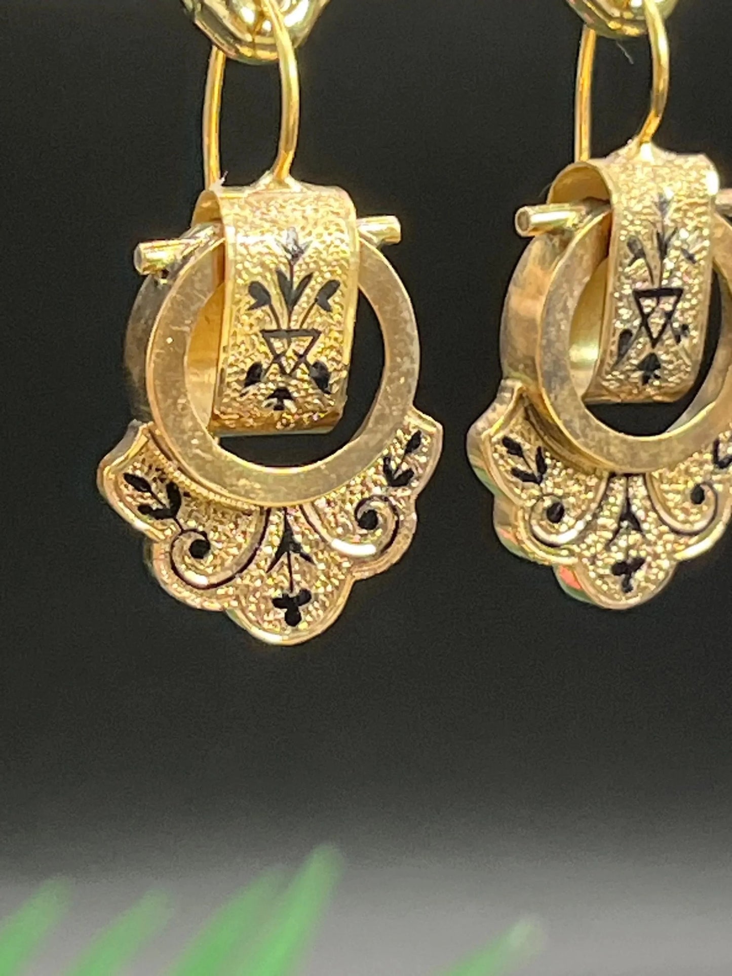 A pair of yellow gold and black enamel drop earrings