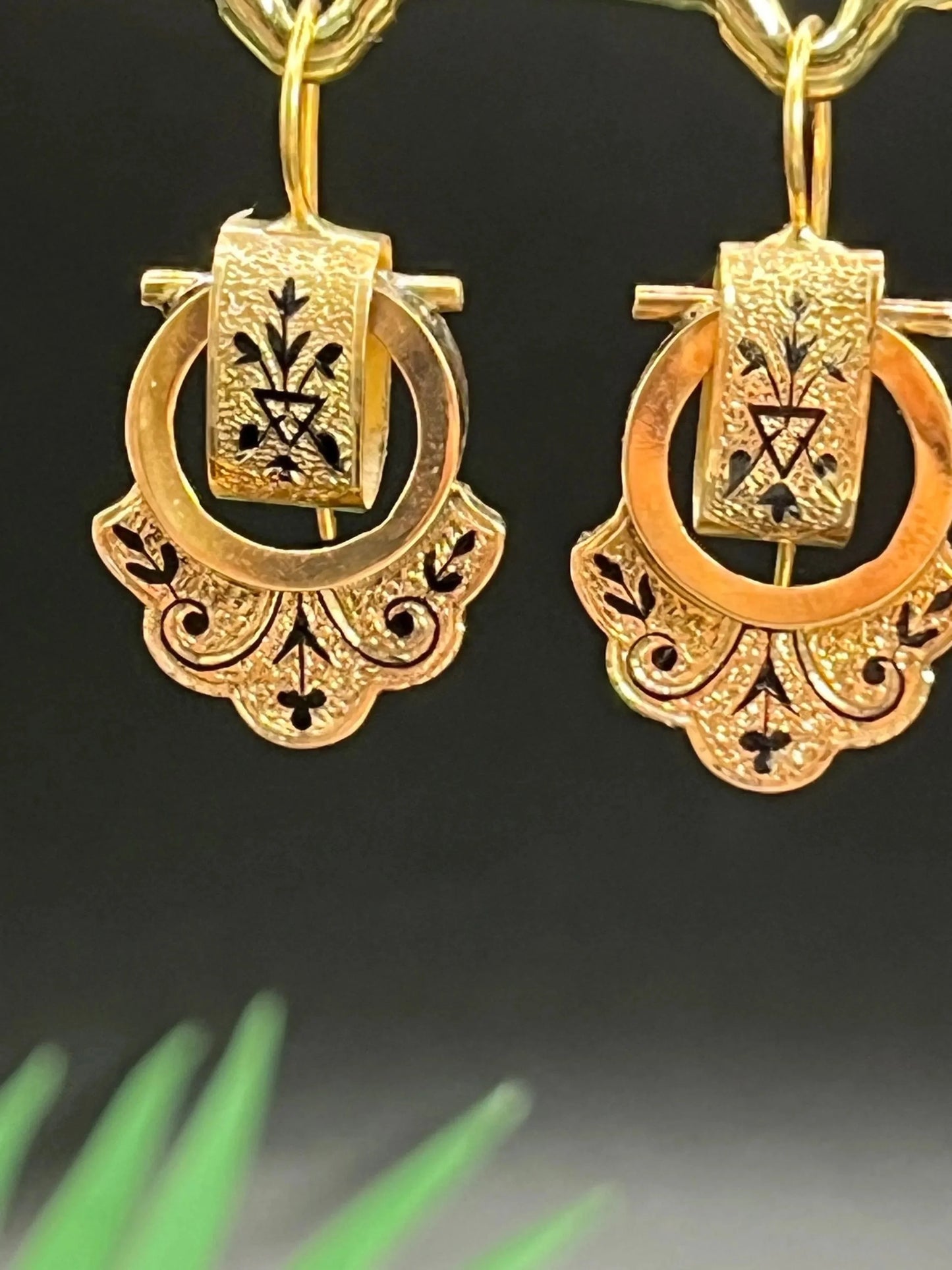 A pair of yellow gold and black enamel drop earrings