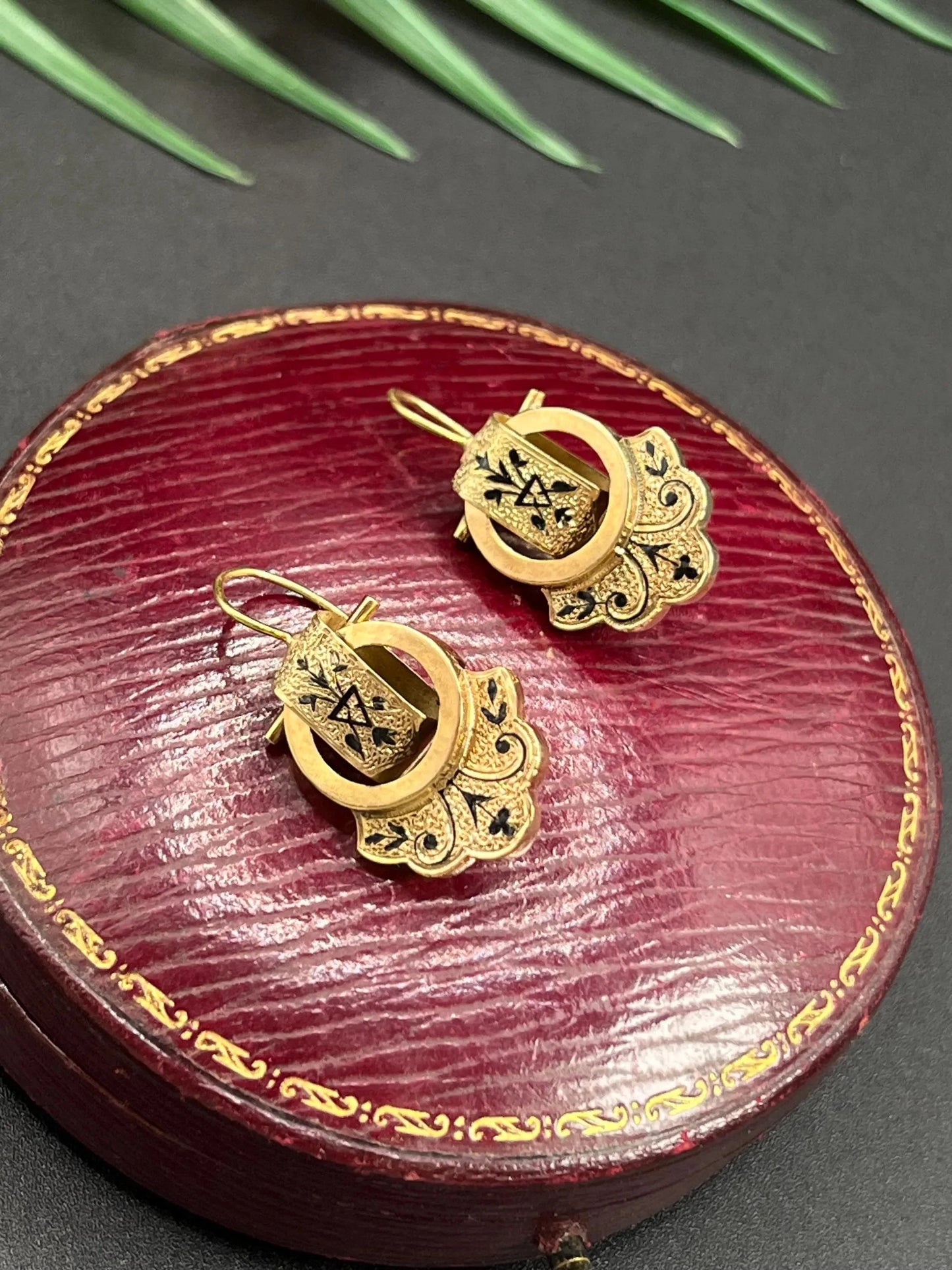 A pair of yellow gold and black enamel drop earrings