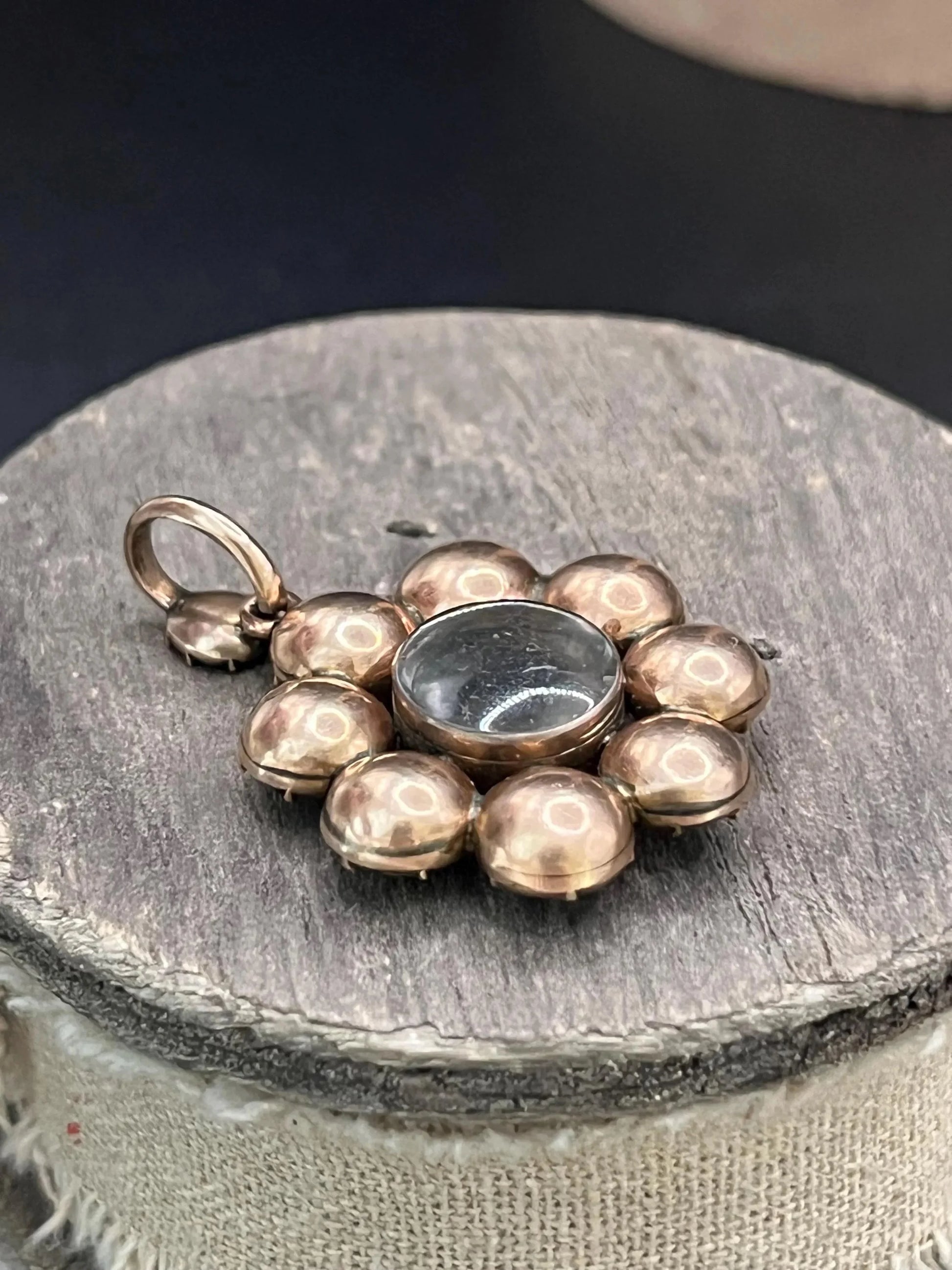 An antique garnet locket pendant in gold