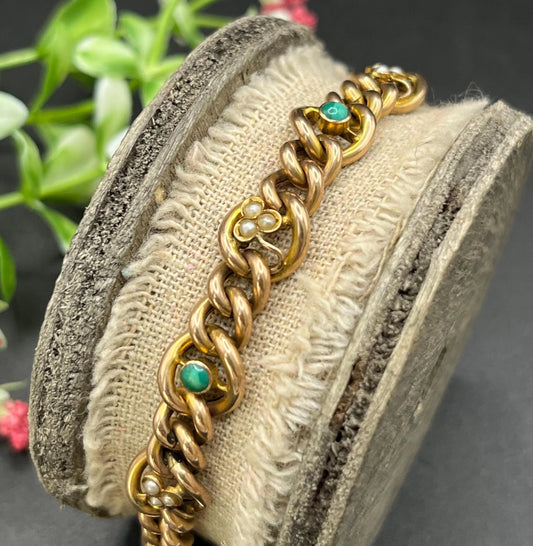 A gold curb link bracelet with turquoise and seed pearls