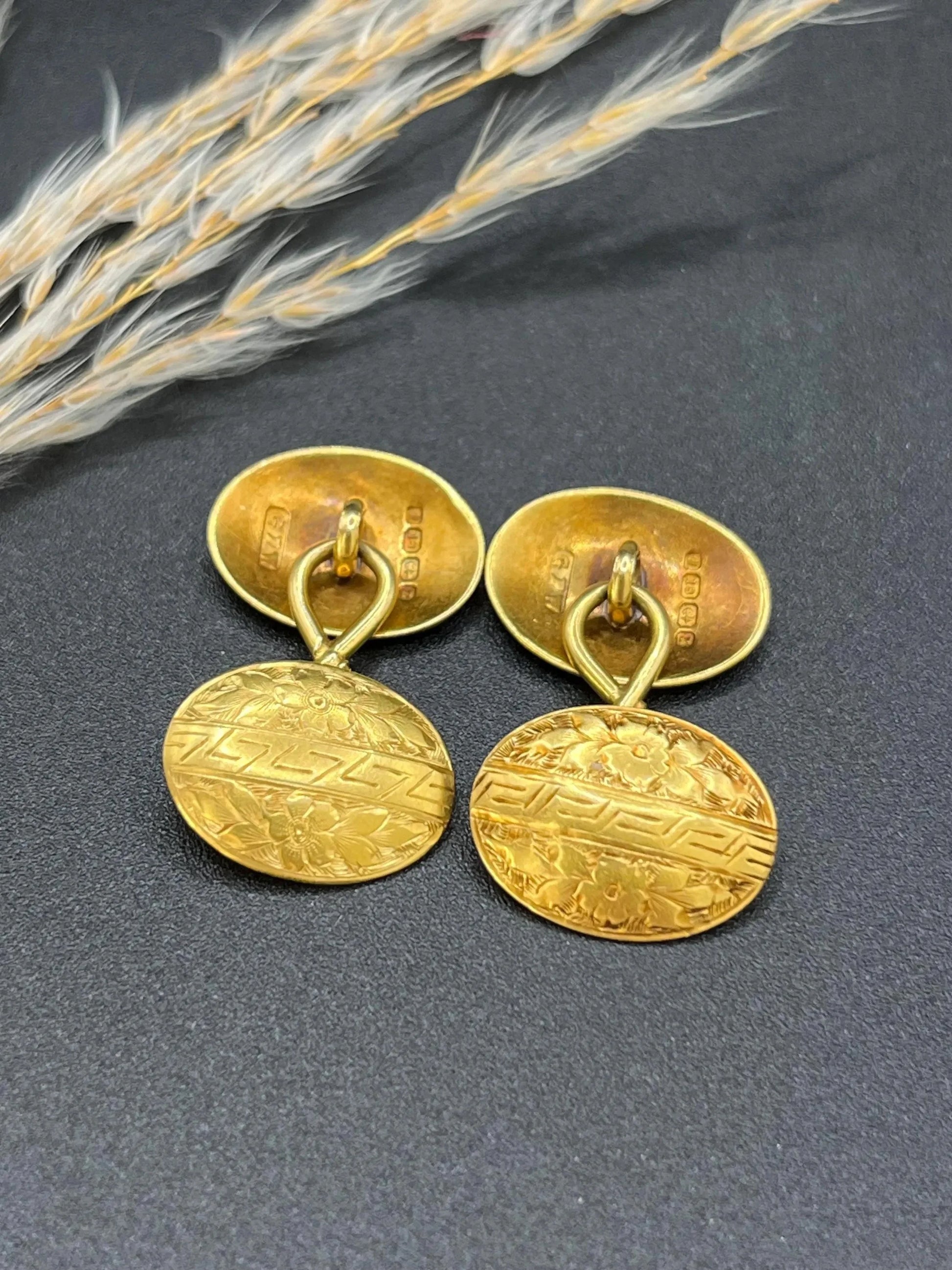 A pair of oval yellow gold floral engraved cufflinks