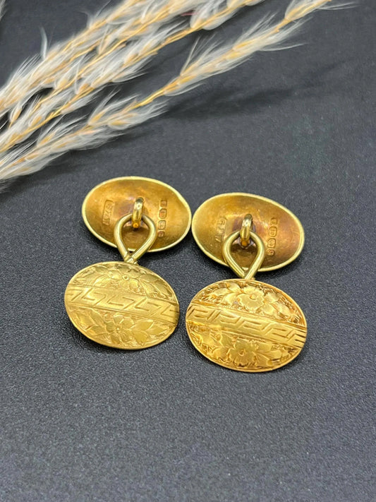 A pair of oval yellow gold floral engraved cufflinks