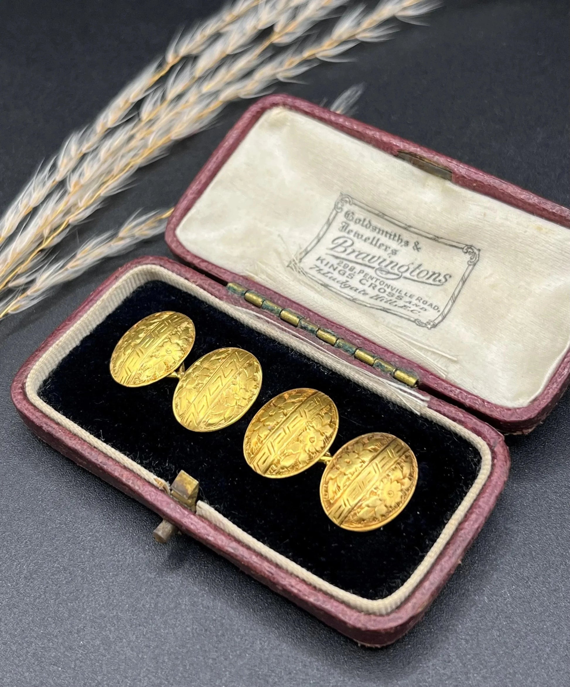 A pair of oval yellow gold floral engraved cufflinks, in an antique box