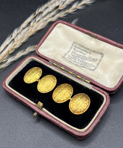 A pair of oval yellow gold floral engraved cufflinks, in an antique box