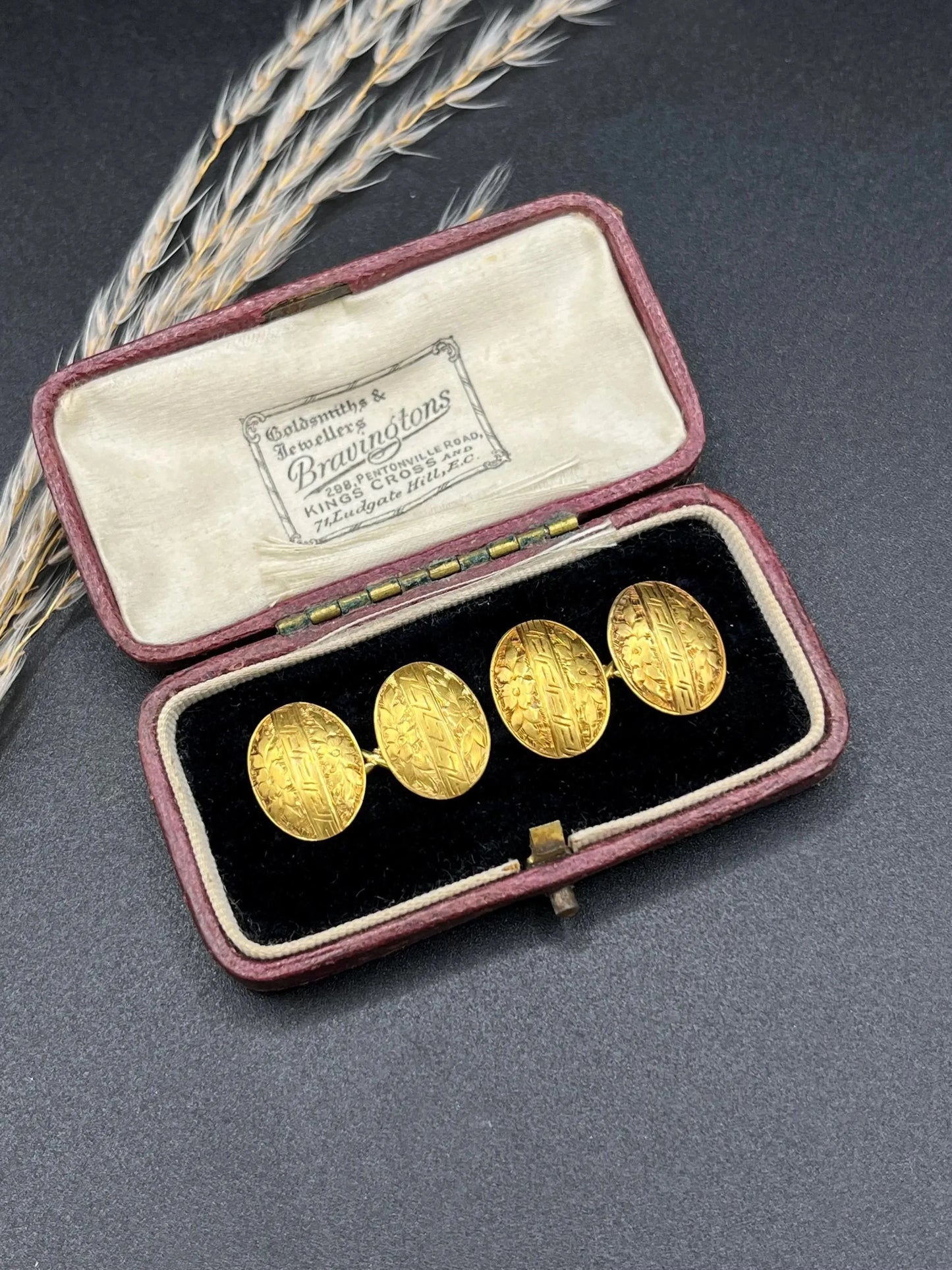A pair of oval yellow gold floral engraved cufflinks, in an antique box