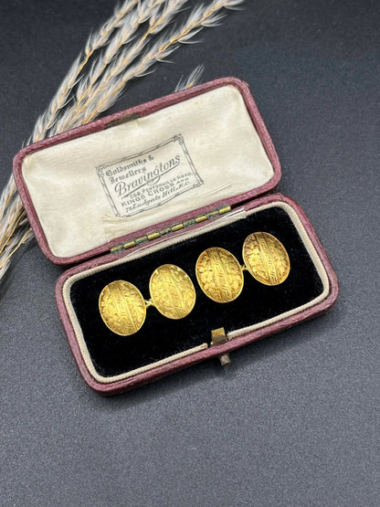 A pair of oval yellow gold floral engraved cufflinks, in an antique box