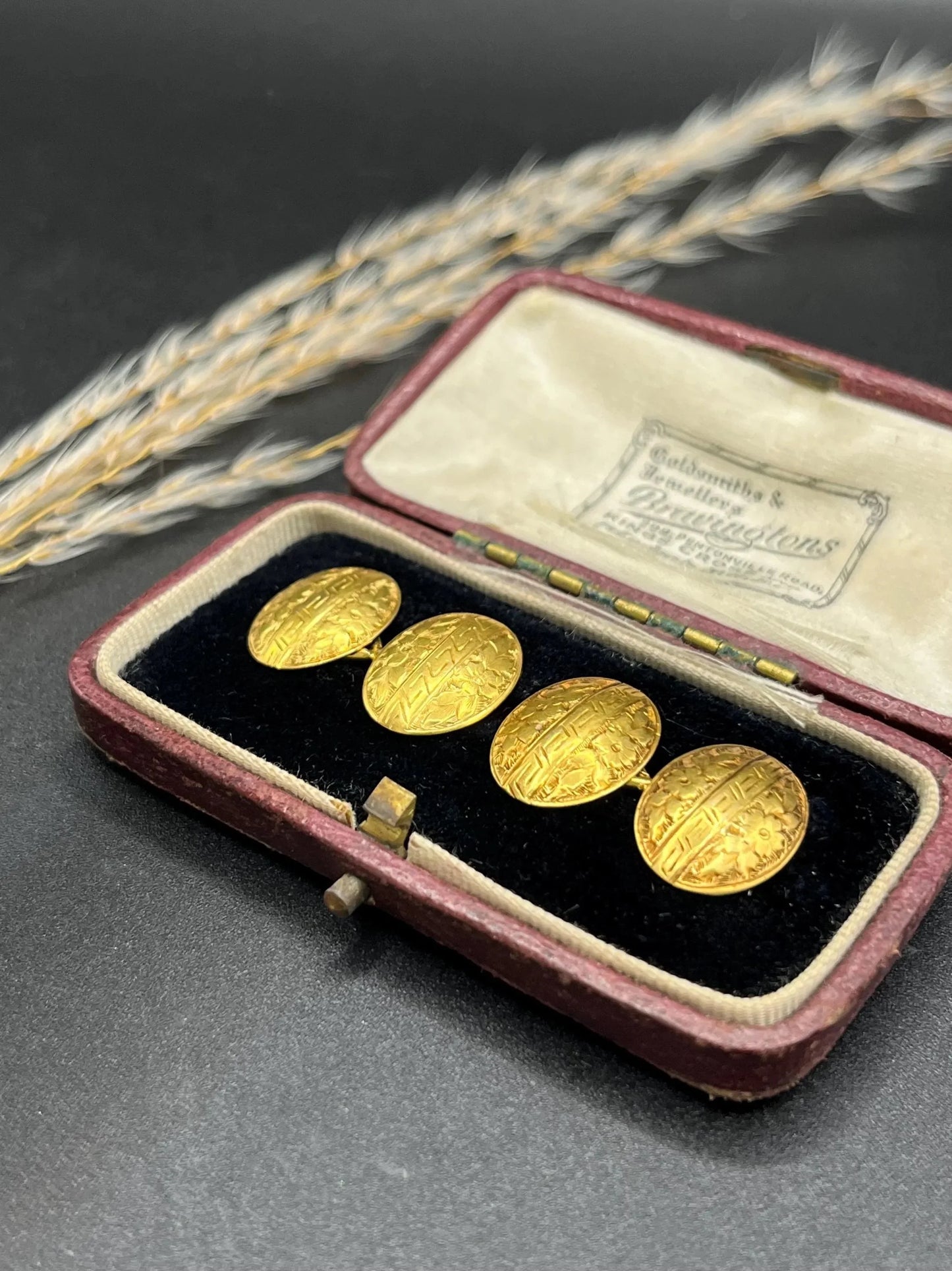 A pair of oval yellow gold floral engraved cufflinks, in an antique box