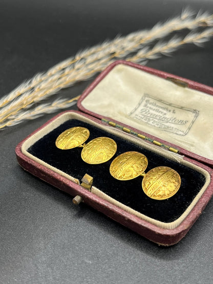 A pair of oval yellow gold floral engraved cufflinks, in an antique box