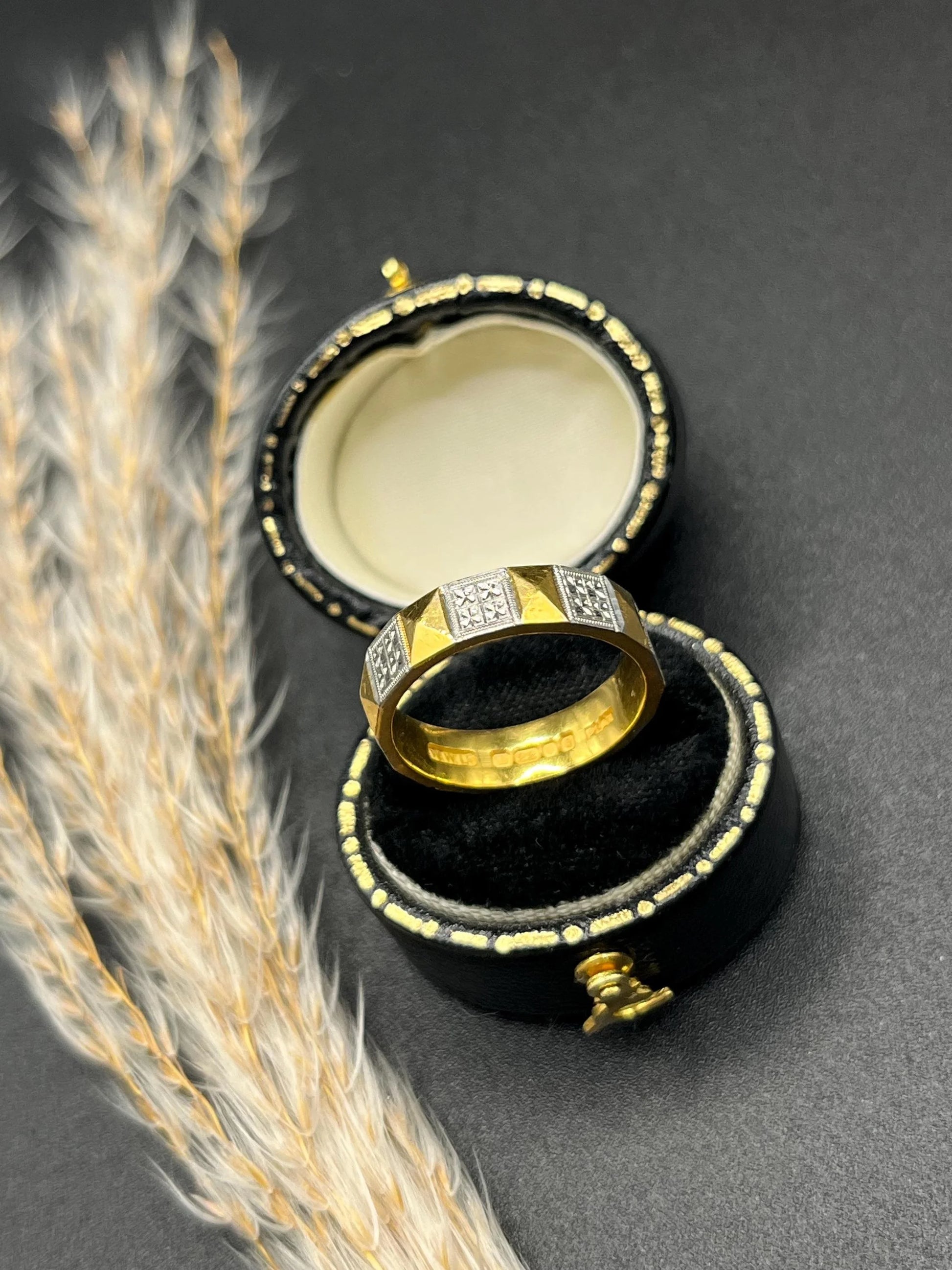 A yellow gold and platinum geometric band ring, in a ring box