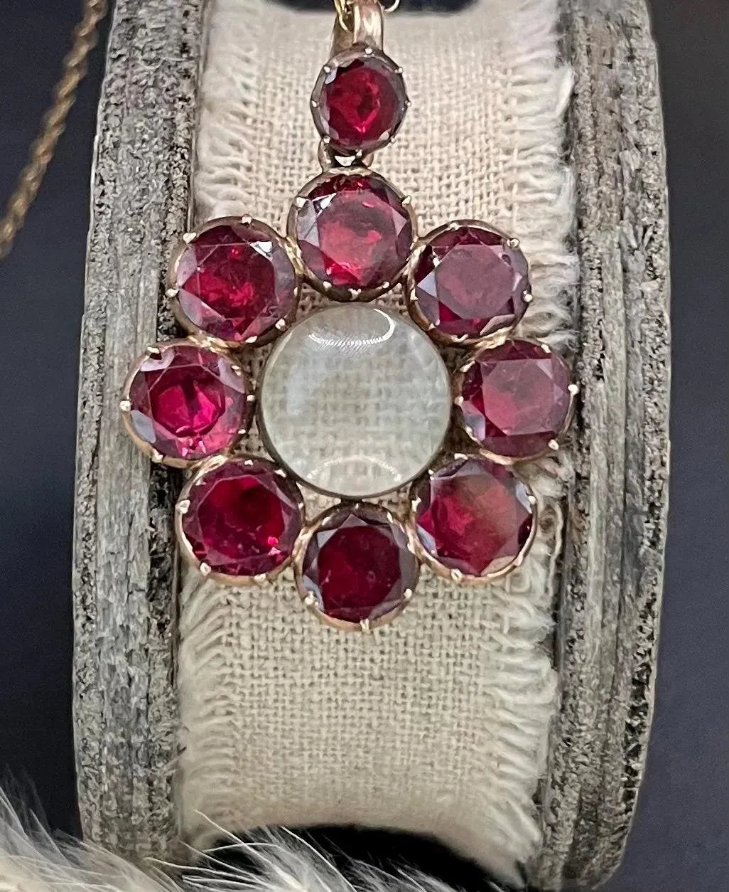 An antique garnet locket pendant in gold