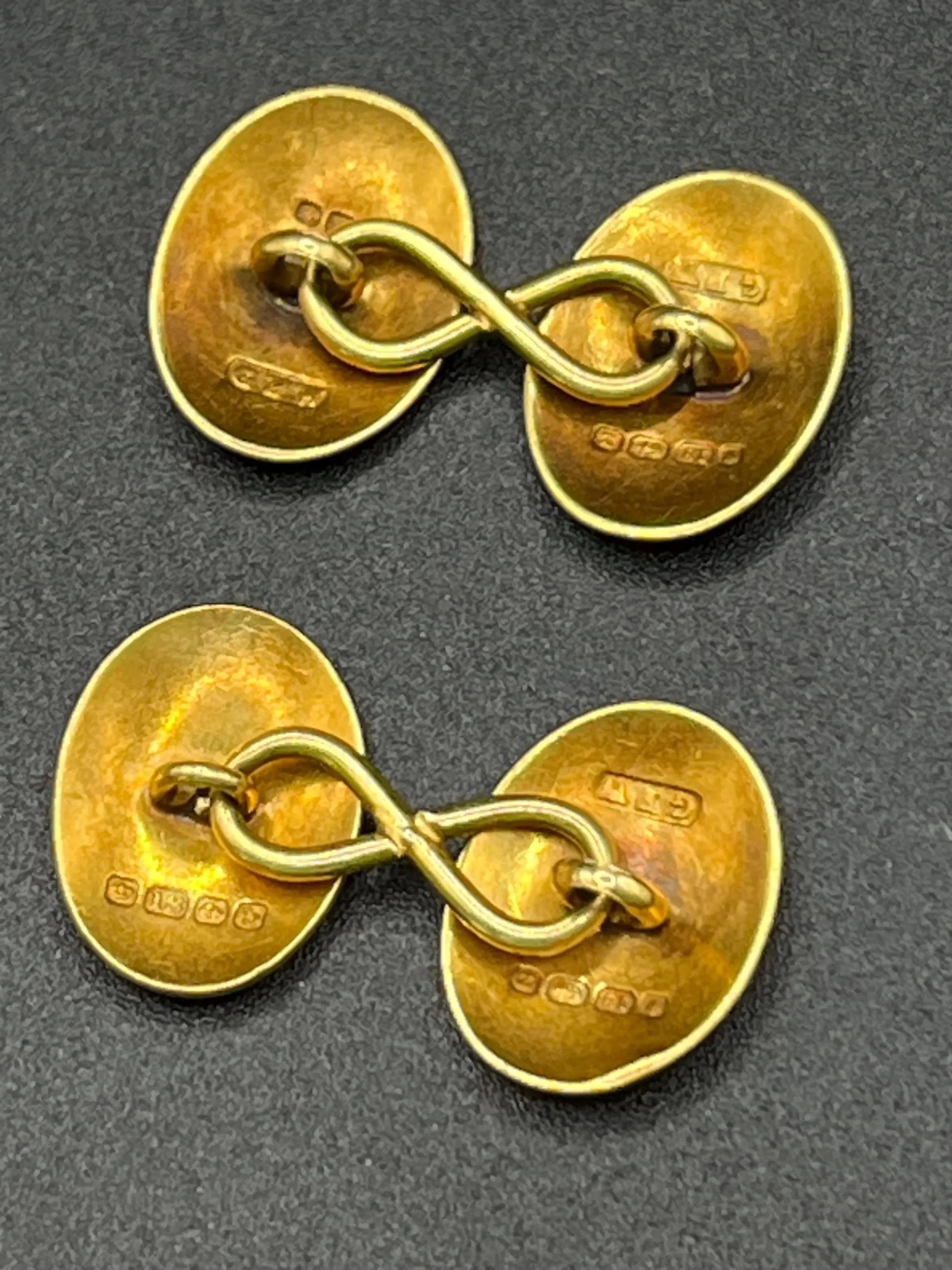 A pair of oval yellow gold cufflinks, with hallmarks
