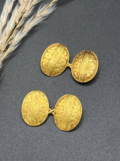 A pair of oval yellow gold floral engraved cufflinks