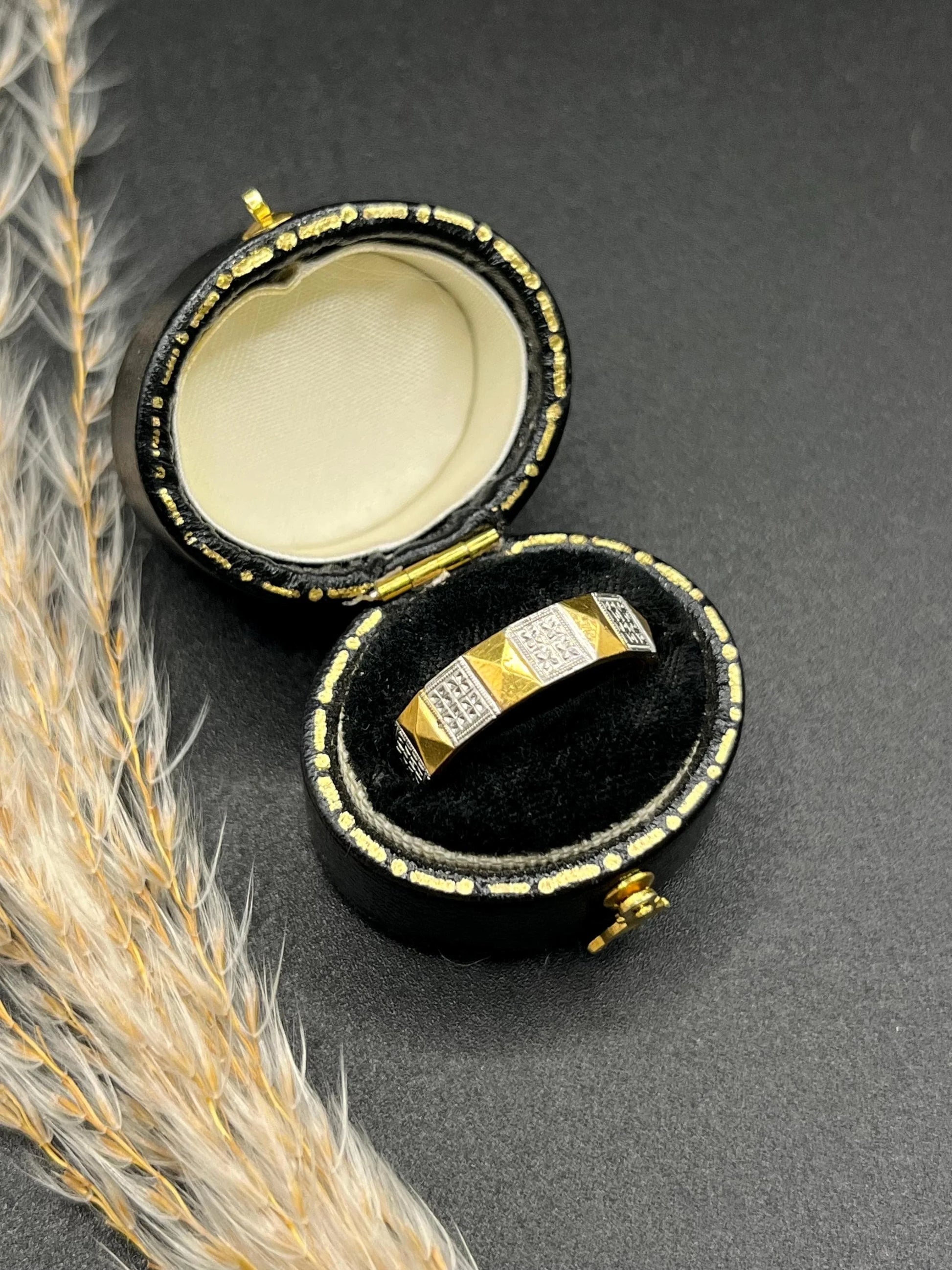A yellow gold and platinum geometric band ring, in a ring box