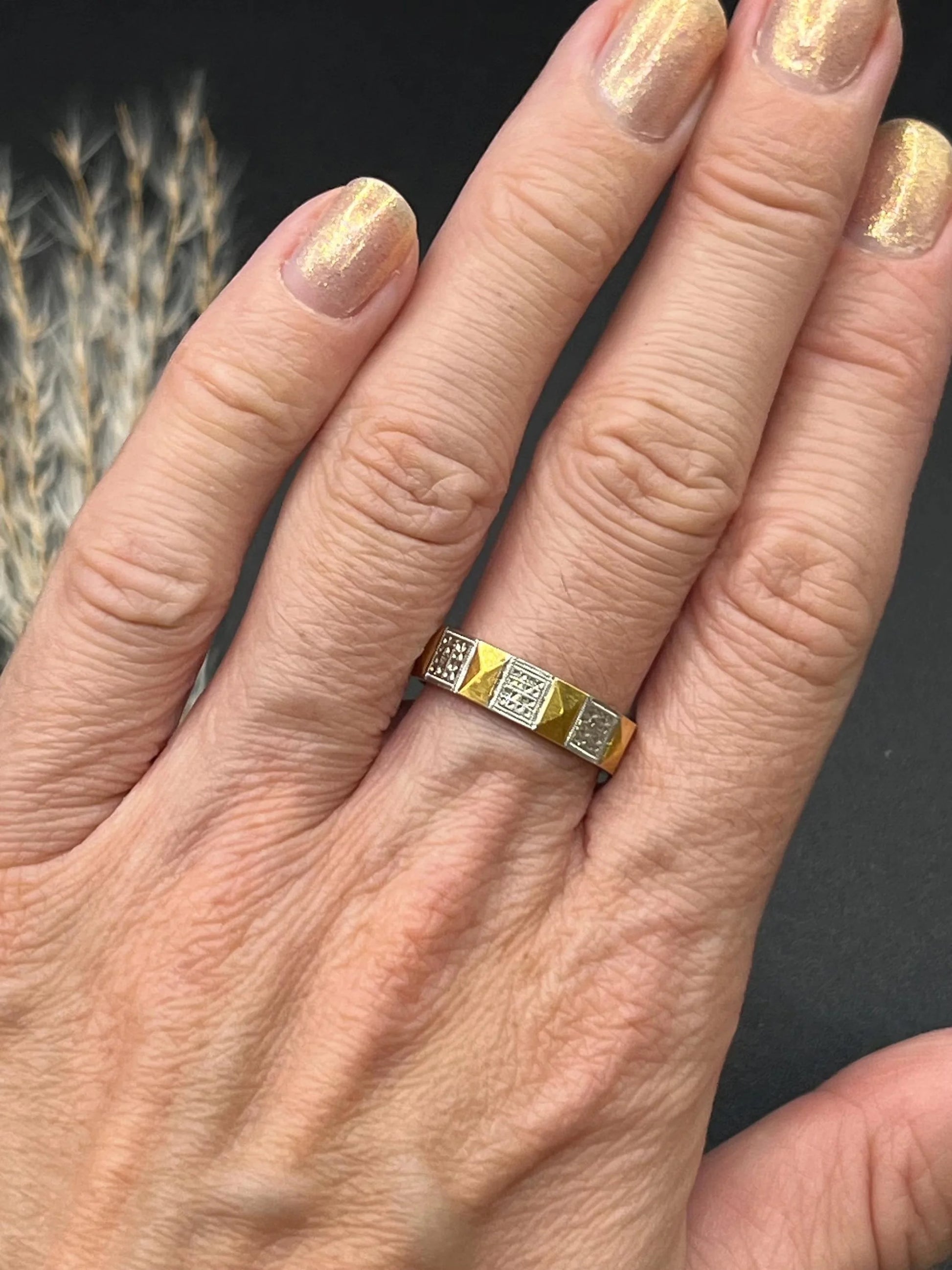 A yellow gold and platinum geometric band ring, modelled on a hand