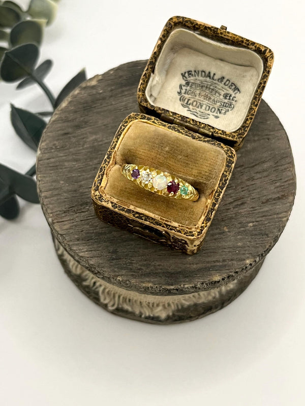 A yellow gold five stone acrostic multi-gemstone ring, in an antique ring box