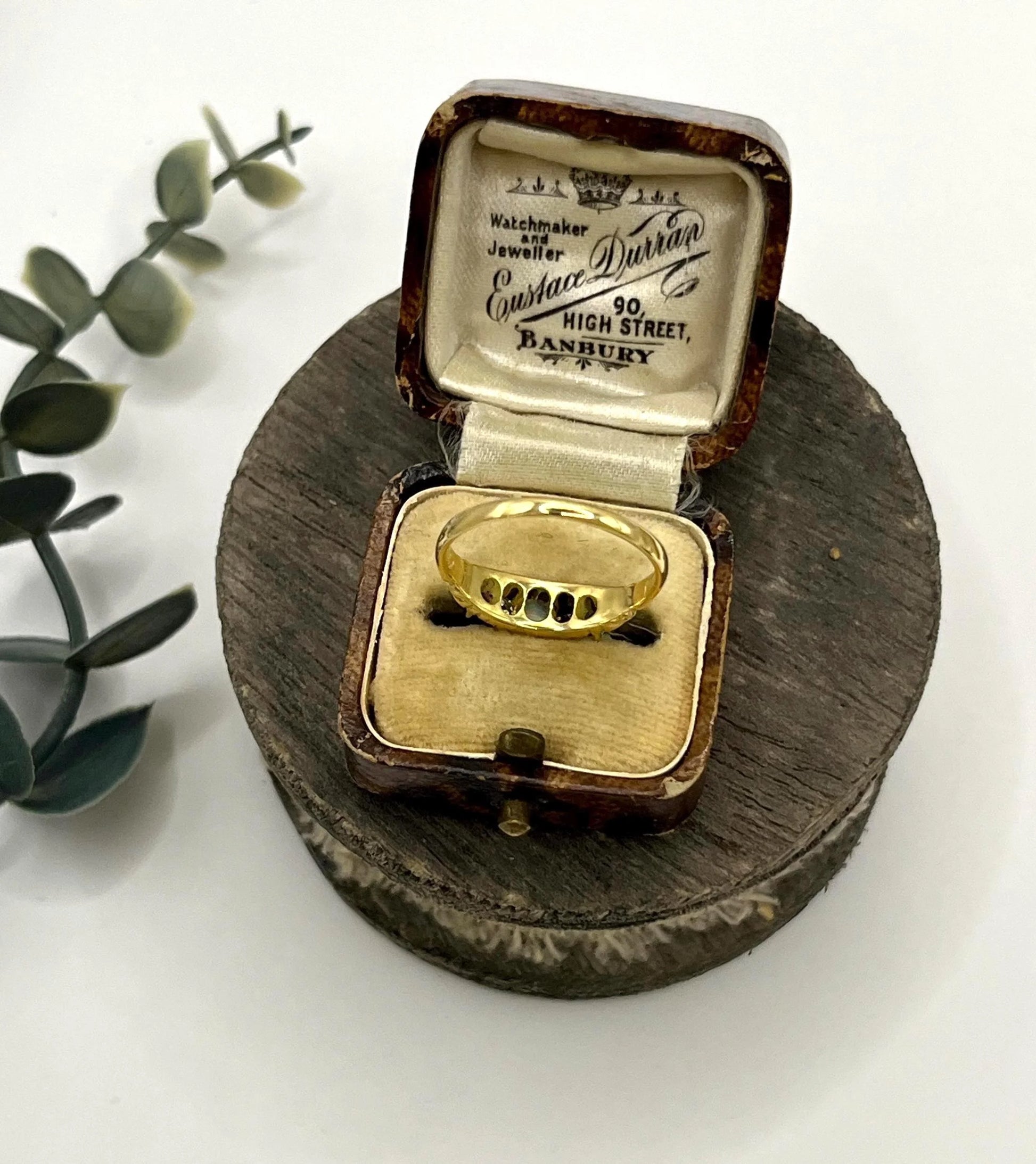 A yellow gold five stone acrostic multi-gemstone ring, in an antique ring box