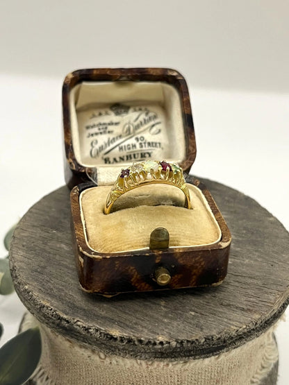 A yellow gold five stone acrostic multi-gemstone ring, in an antique ring box