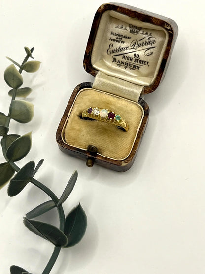 A yellow gold five stone acrostic multi-gemstone ring, in an antique ring box