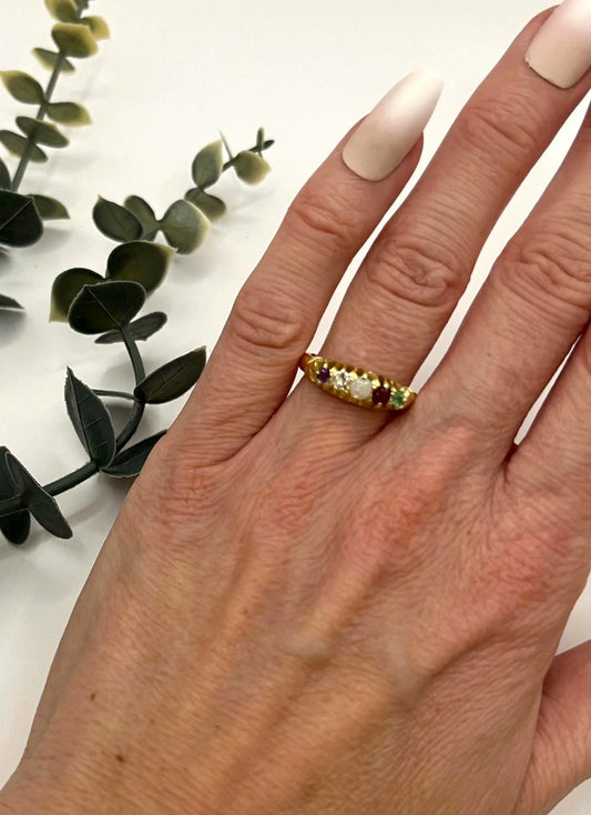 A yellow gold five stone acrostic multi-gemstone ring, modelled on a hand