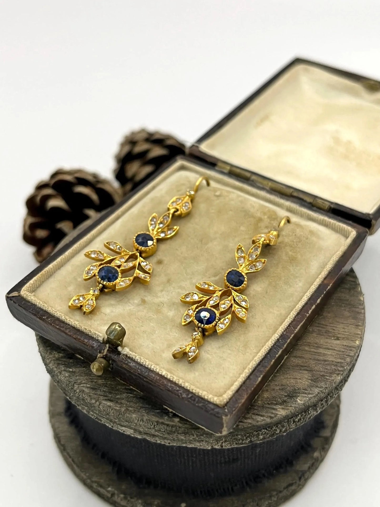 A pair of sapphire and diamond foliate drop earrings in yellow gold, in an antique box