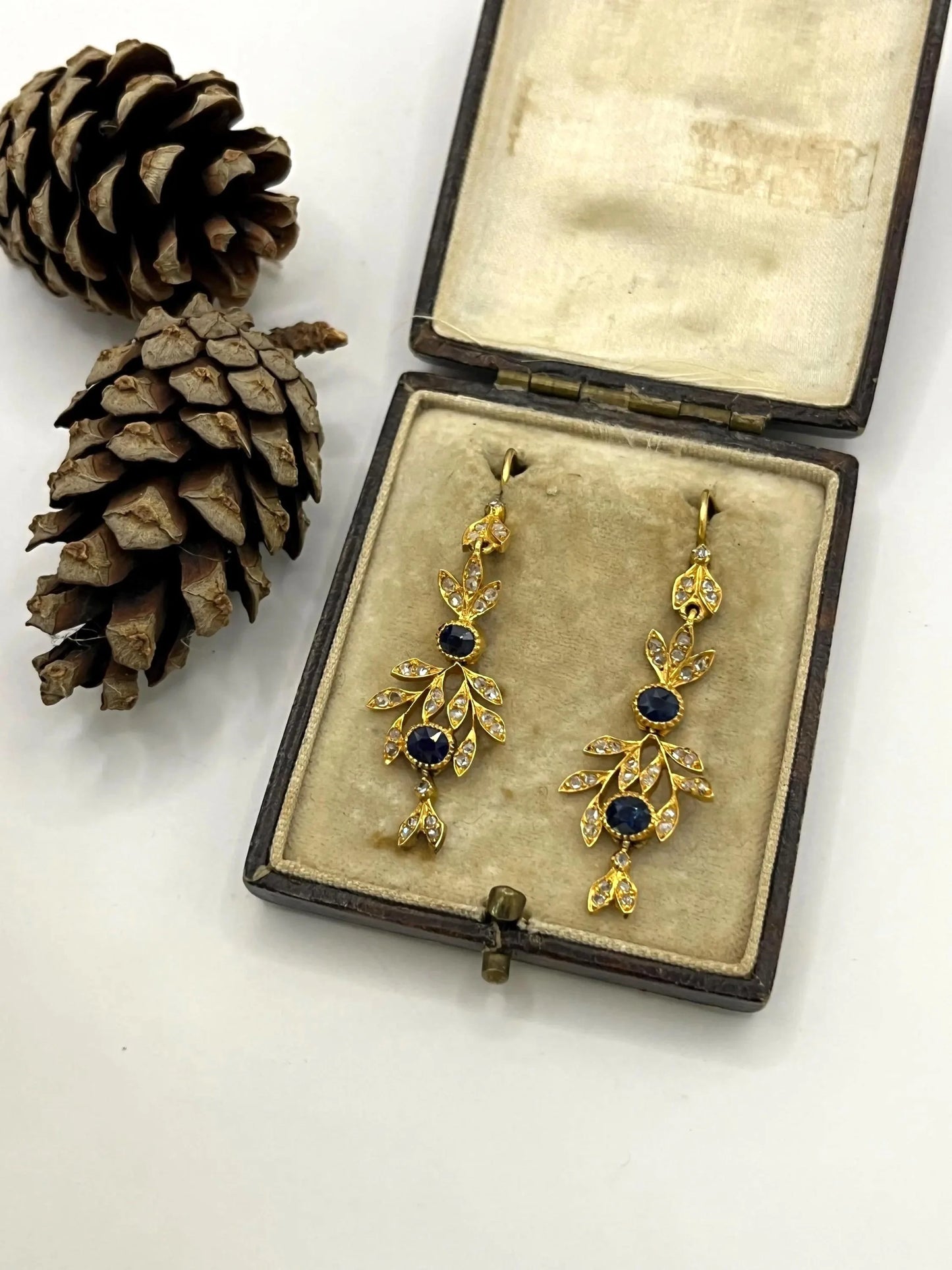 A pair of sapphire and diamond foliate drop earrings in yellow gold, in an antique box