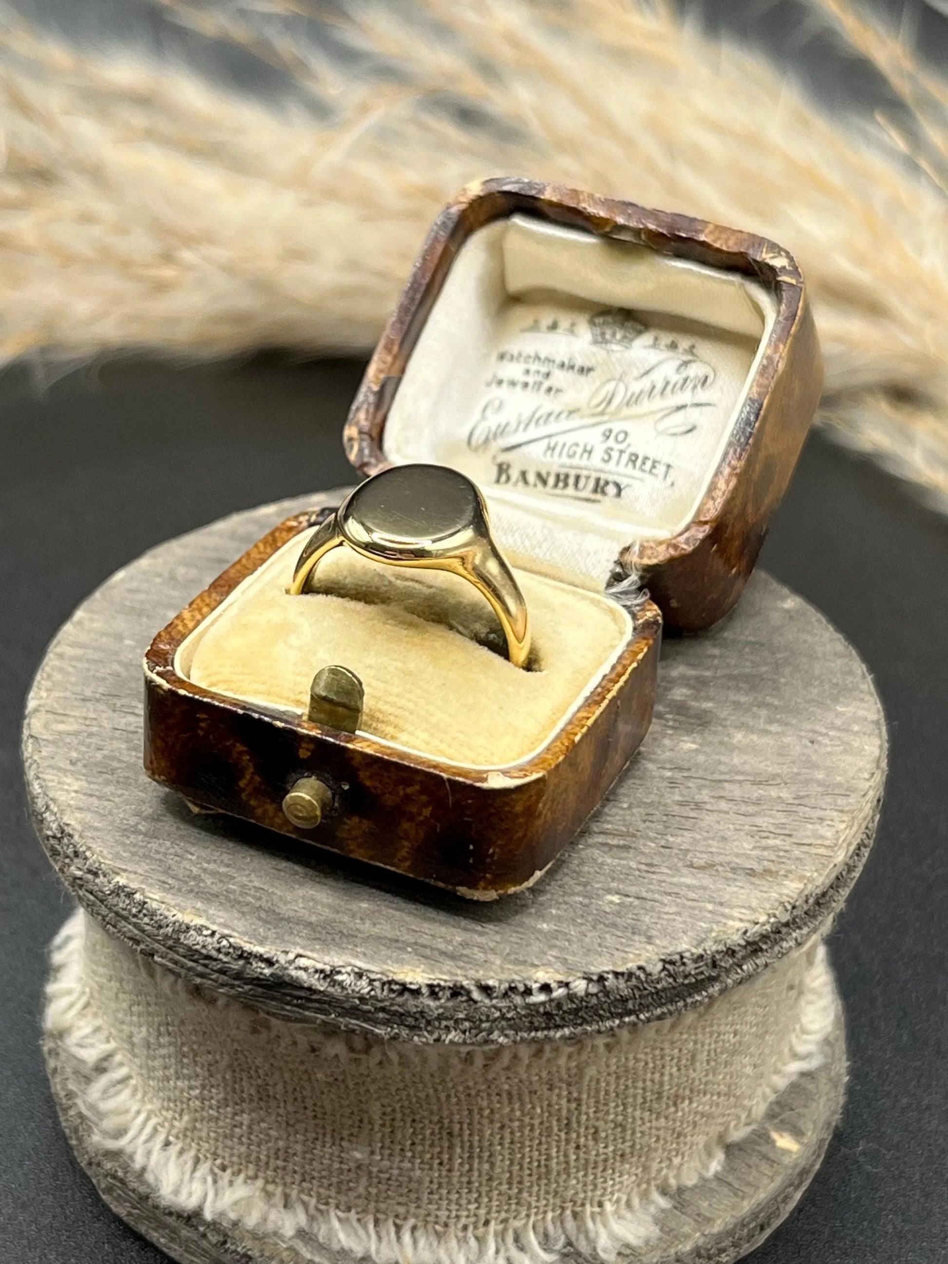 A yellow gold plain oval signet ring, in a box