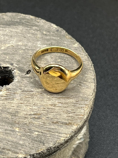 A yellow gold plain oval signet ring, hallmarked