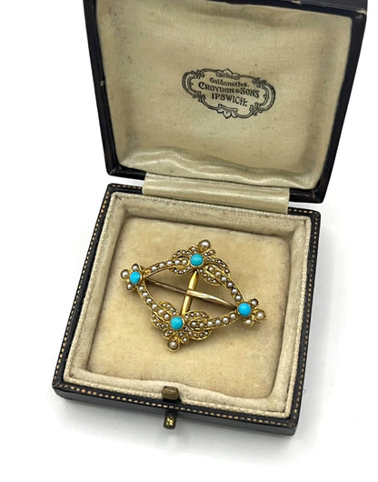 A yellow gold buckle style brooch/pendant with turquoise and seed pearls, in an antique box