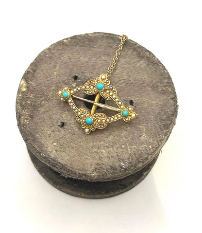 A yellow gold buckle style brooch/pendant with turquoise and seed pearls, with a chain