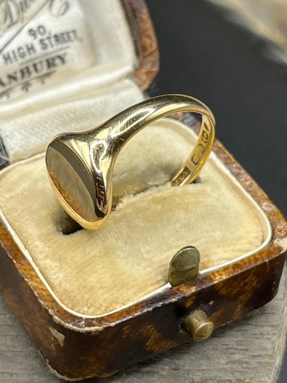 A yellow gold plain oval signet ring, hallmarked