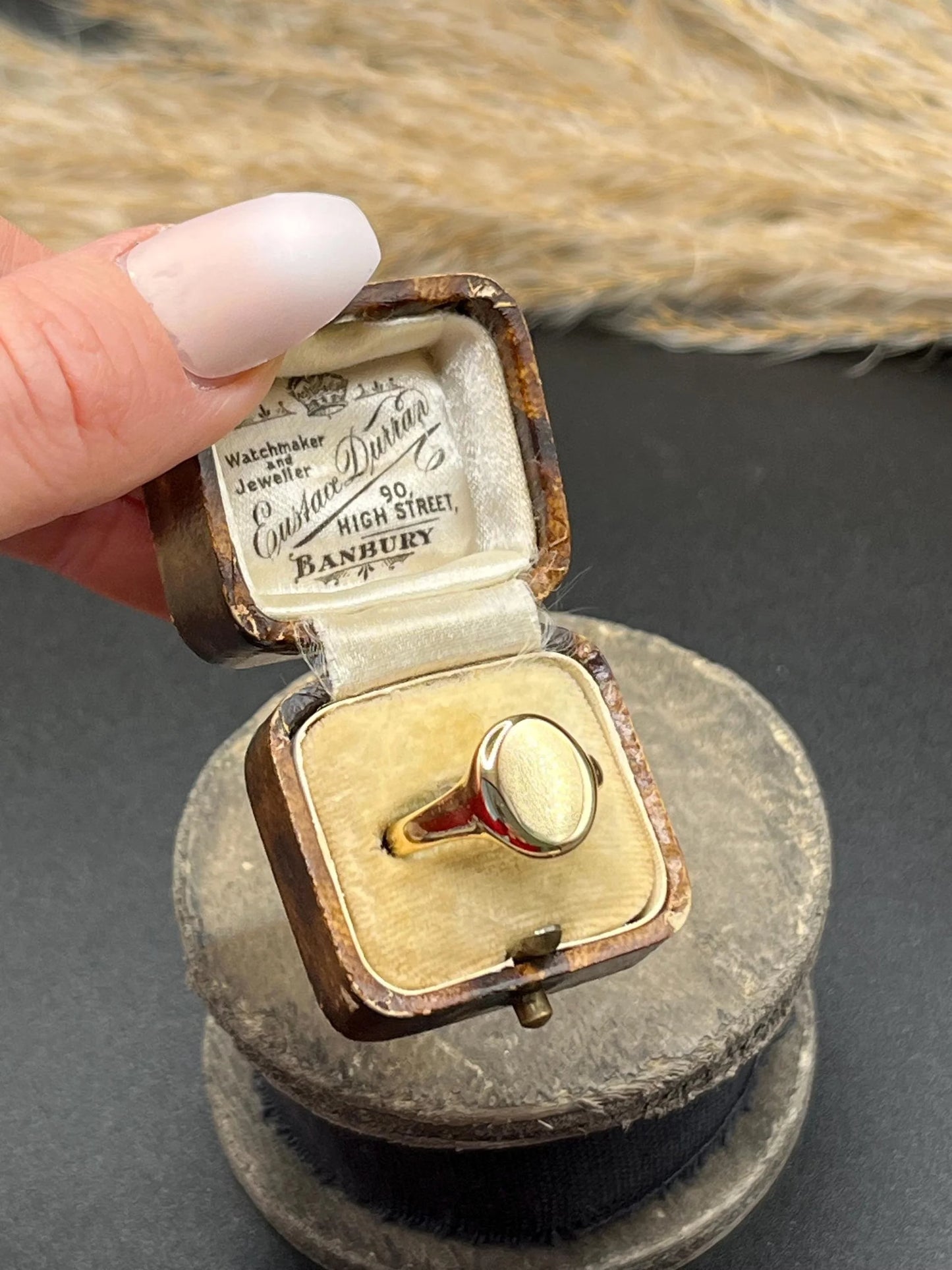 A yellow gold plain oval signet ring, in a ring box