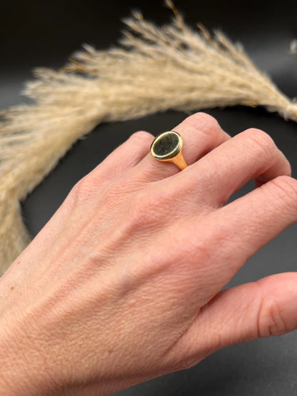 A yellow gold plain oval signet ring, modelled on a hand