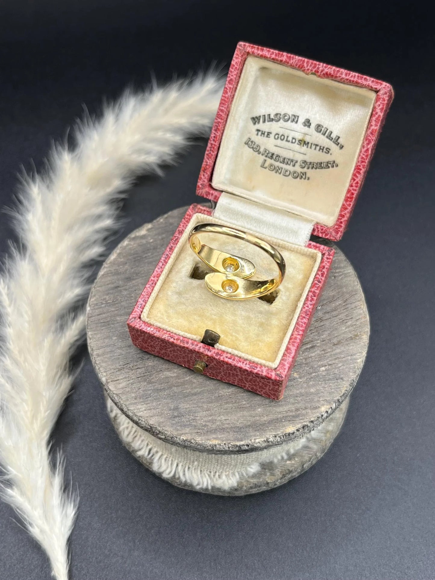 A yellow gold double headed snake ring with diamonds, in an antique ring box