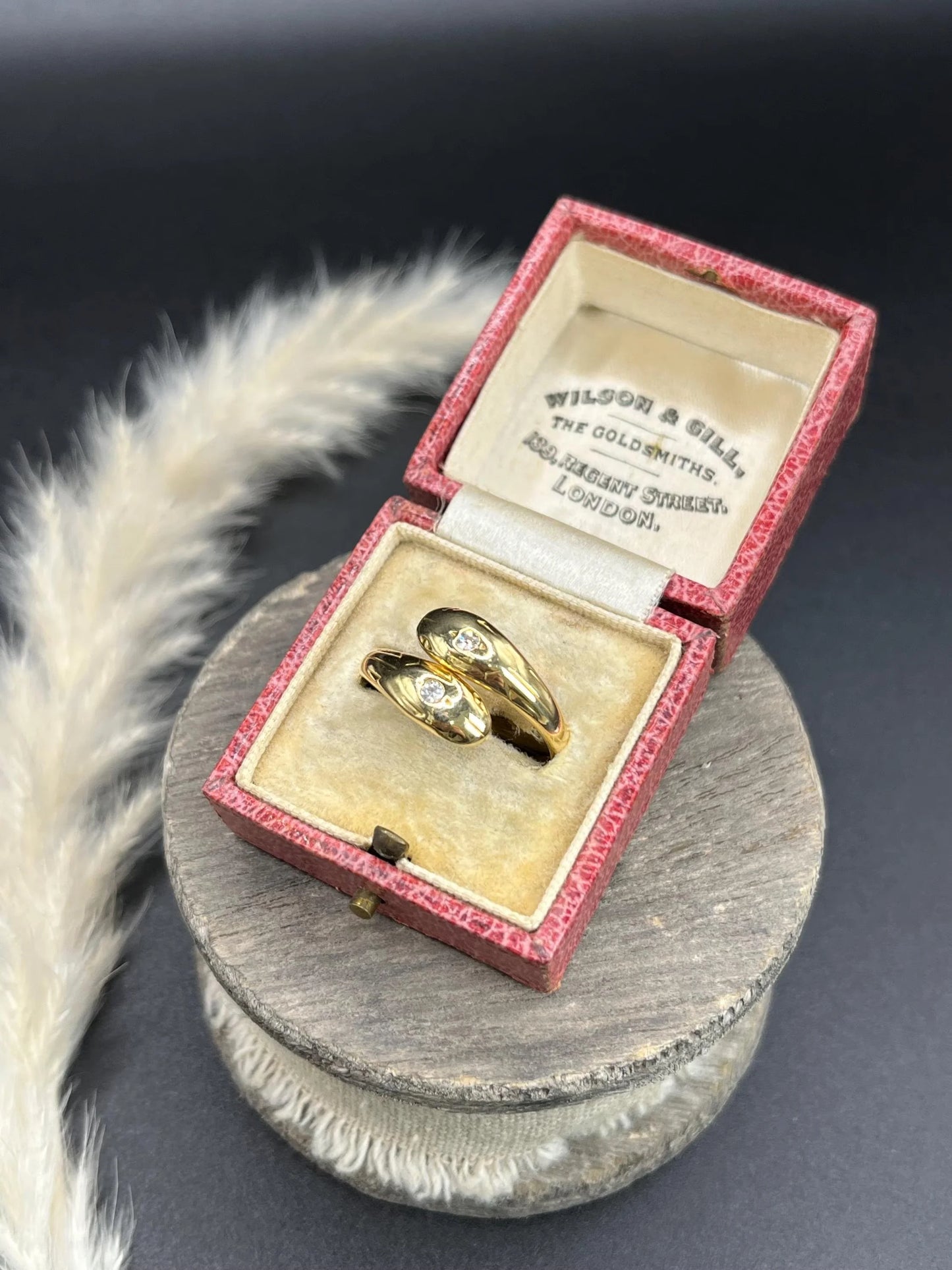 A yellow gold double headed snake ring with diamonds, in an antique ring box