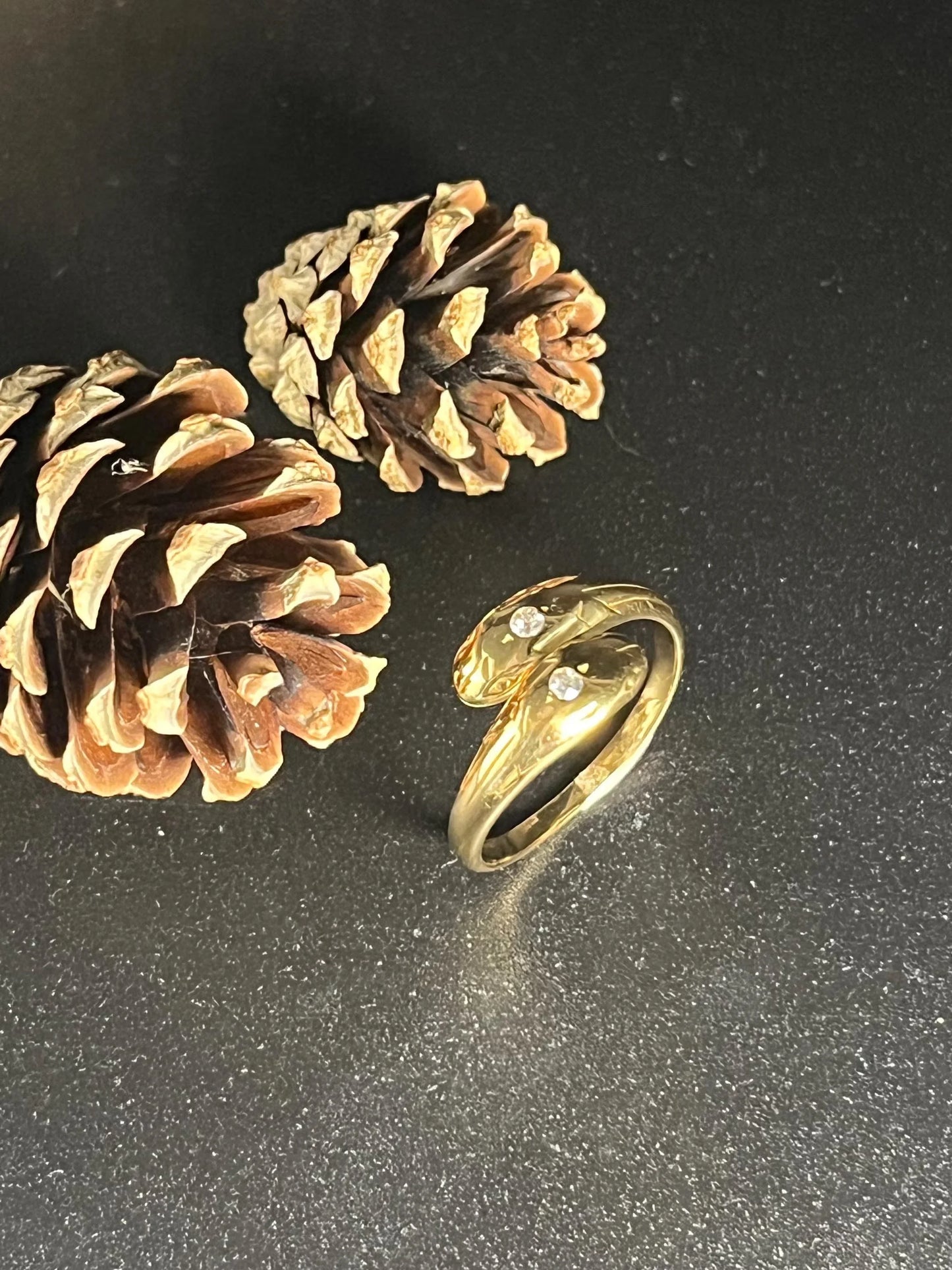 A yellow gold double headed snake ring with diamonds
