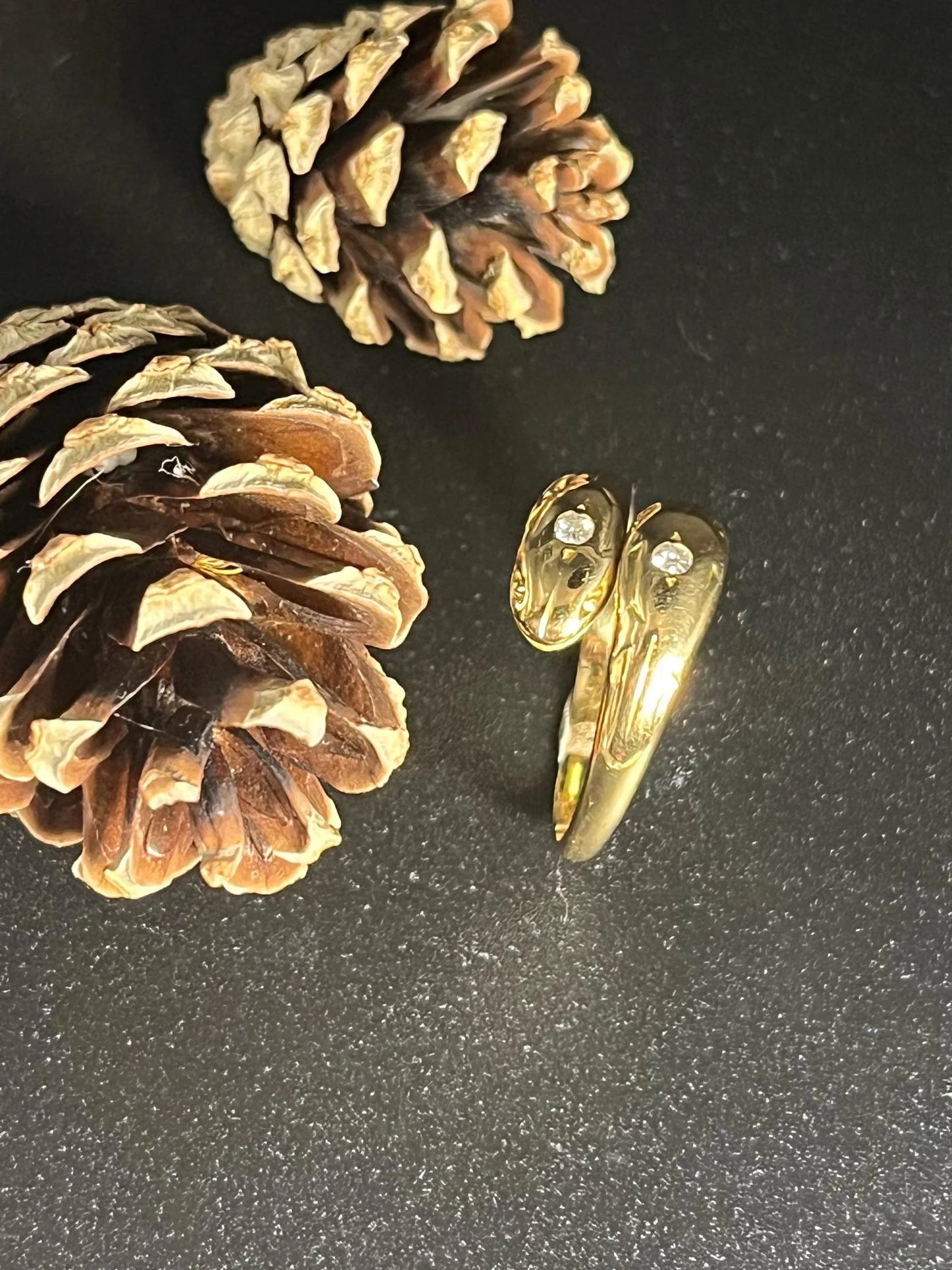 A yellow gold double headed snake ring with diamonds