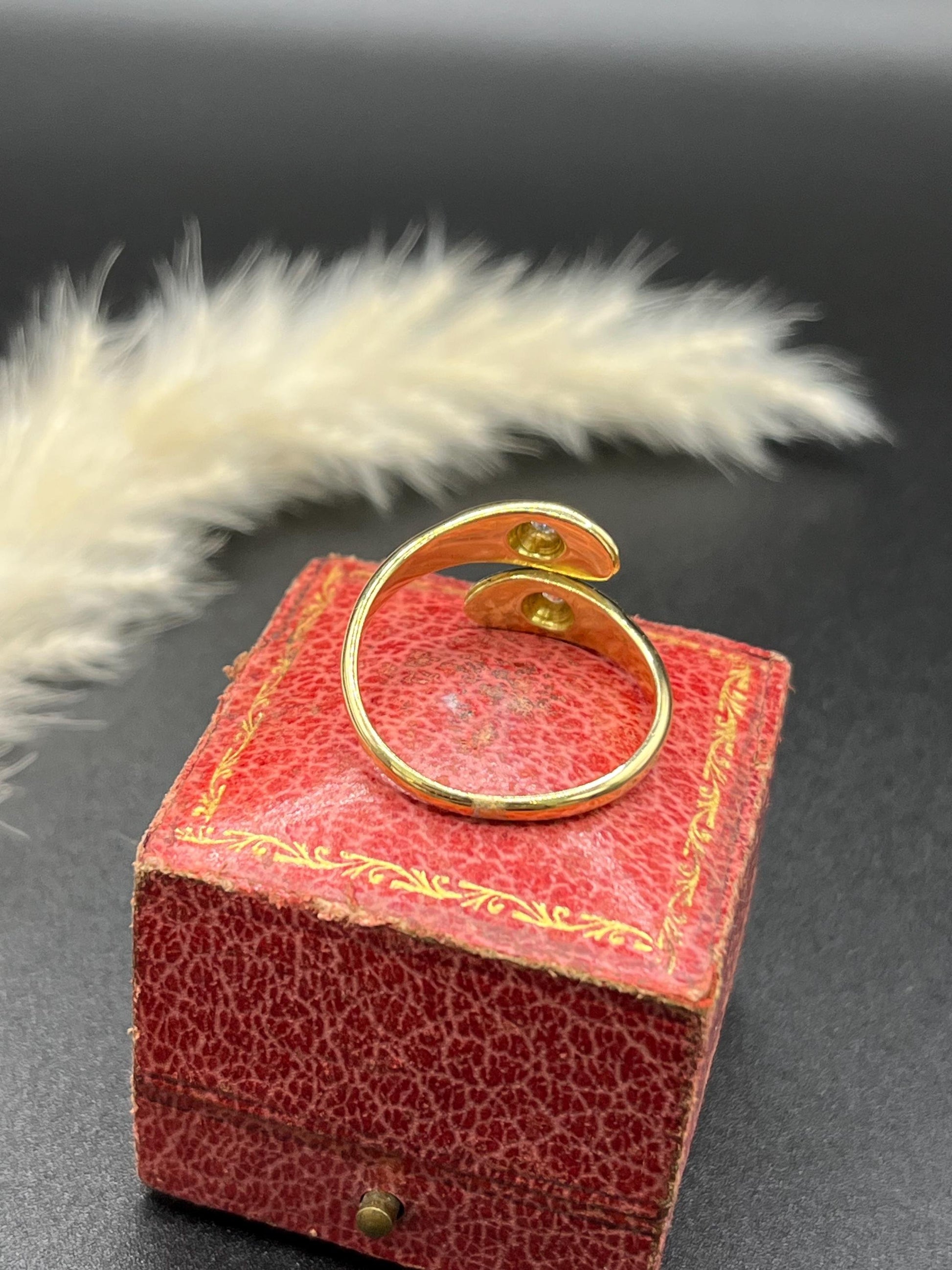 A yellow gold double headed snake ring with diamonds