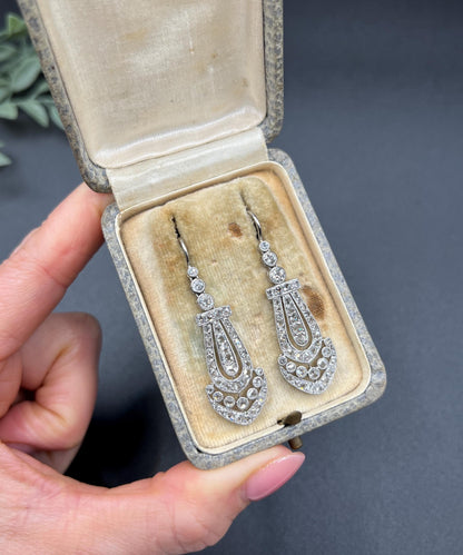 A pair of antique platinum diamond drop earrings, in a box
