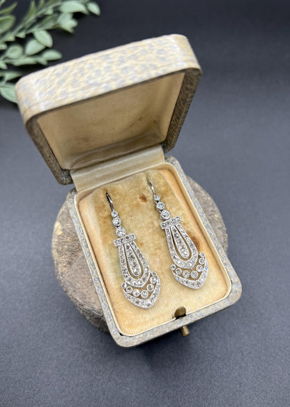 A pair of antique platinum diamond drop earrings, in a box
