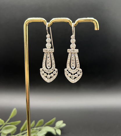 A pair of antique platinum diamond drop earrings