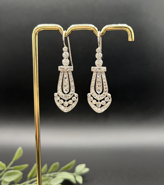 A pair of antique platinum diamond drop earrings