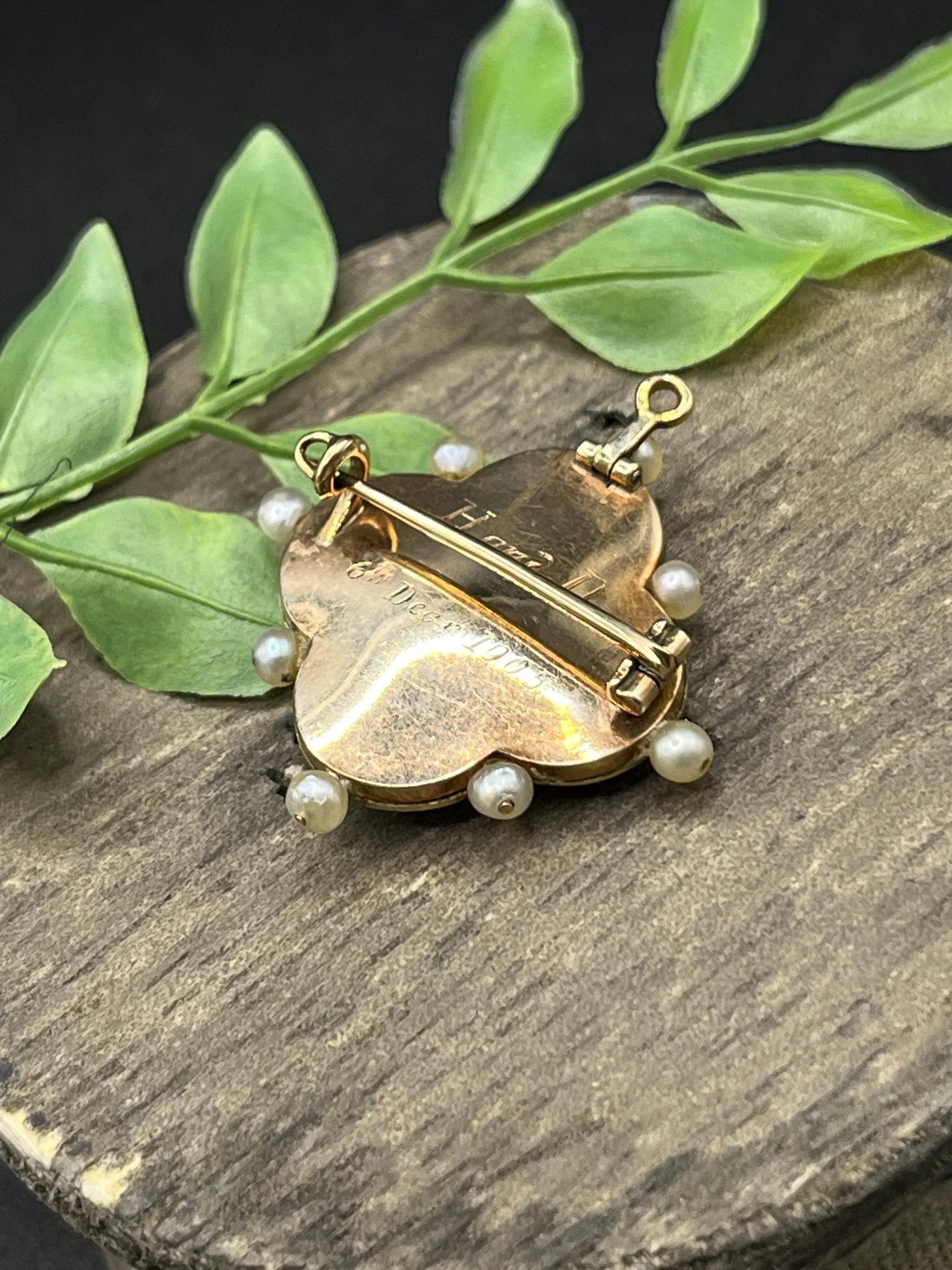 A diamond flower, blue enamel and pearl brooch in yellow gold, engraved on the back