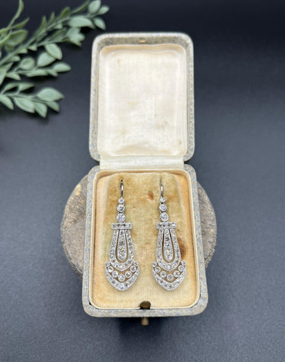 A pair of antique platinum diamond drop earrings, in a box