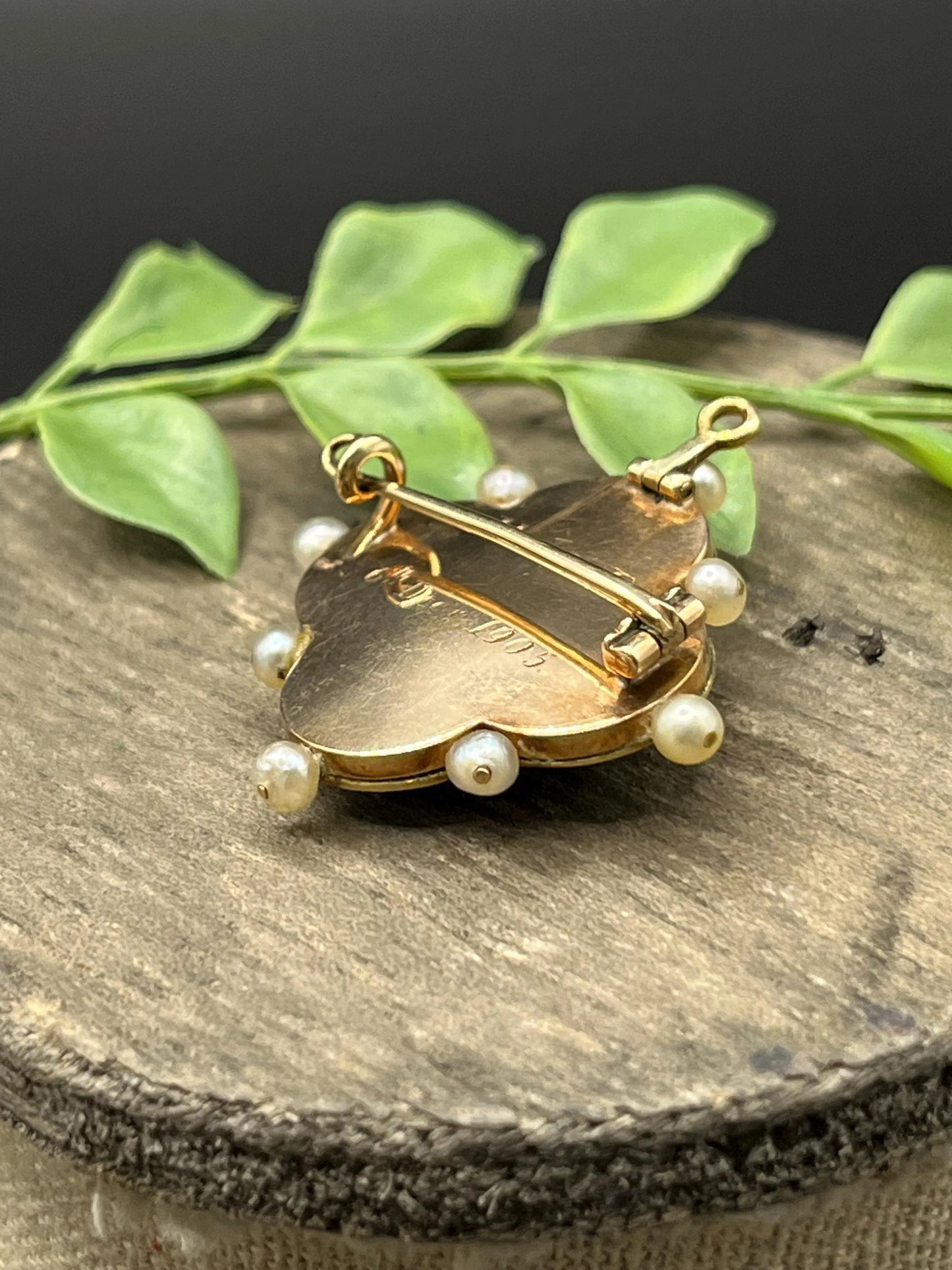A diamond flower, blue enamel and pearl brooch in yellow gold, engraved on the back