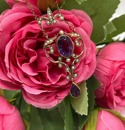 An amethyst and seed pearl pendant necklace in yellow gold