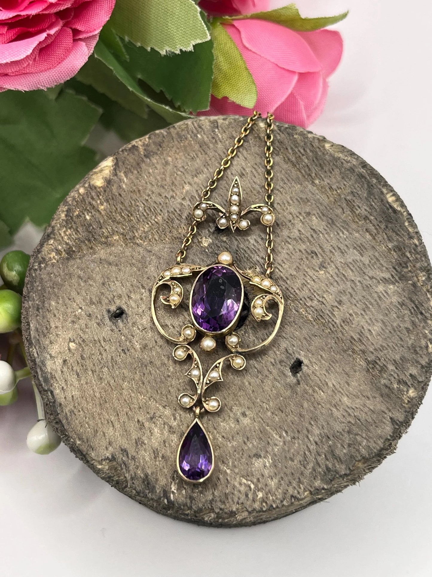 An amethyst and seed pearl pendant necklace in yellow gold