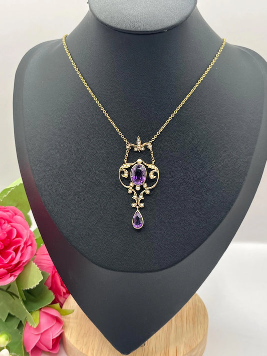 An amethyst and seed pearl pendant necklace in yellow gold