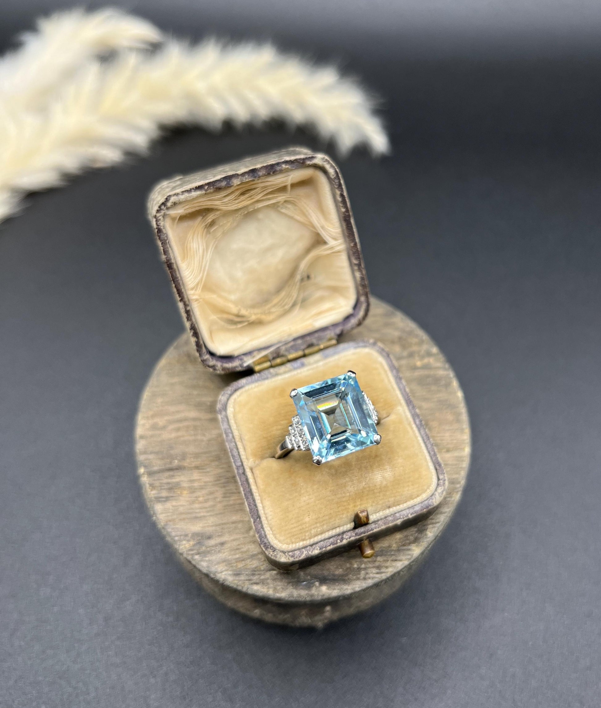 A large aquamarine and diamond dress ring in platinum, in a ring box