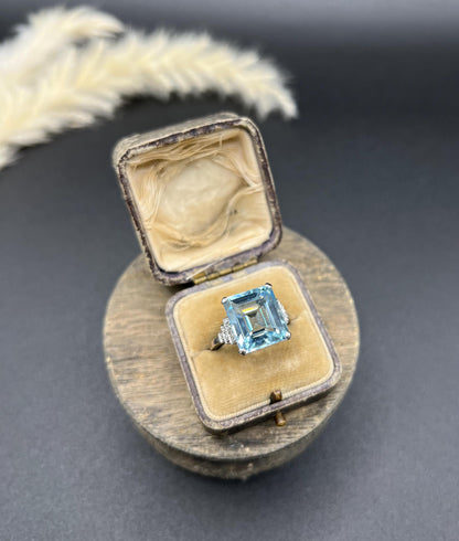 A large aquamarine and diamond dress ring in platinum, in a ring box